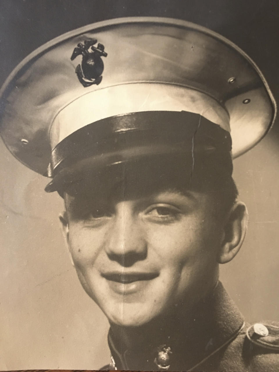 In this undated image provided by the Pedersen family, World War II veteran Jerry Pedersen poses in uniform during his time in the U.S. Marines. Pedersen, who was aboard the USS Missouri on Sept. 2, 1945, and watched the Japanese surrender, will be one of several dozen aging U.S. veterans traveling to Pearl Harbor in Hawaii to mark the 75th anniversary of the event, even if it means the vulnerable group may be risking their lives again amid the coronavirus pandemic. (75th WWII Commemoration Committee/Pedersen family via AP)