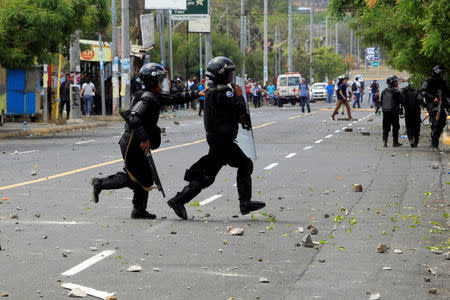 Riot police cross a street during a protest against reforms that implement changes to the pension plans of the Nicaraguan Social Security Institute (INSS) in Managua, Nicaragua April 19, 2018. REUTERS/Oswaldo Rivas