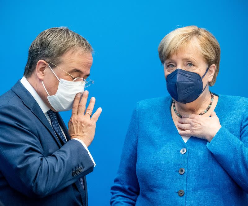 Christian Democratic Union (CDU) leader Laschet talks to Chancellor Merkel before a CDU leadership meeting in Berlin