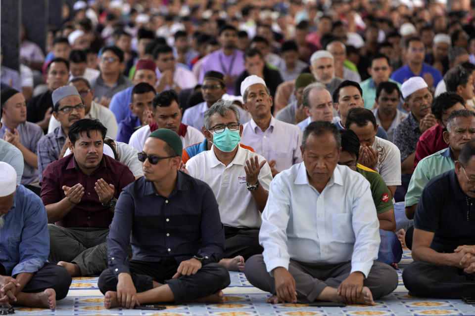 Malaysian Muslims attend Friday prayers at the National Mosque in Kuala Lumpur, Malaysia, Friday, Feb. 28, 2020. The speaker of Malaysia's House rejected interim leader Mahathir Mohamad's call for a vote next week to chose a new premier, deepening the country's political turmoil after the ruling alliance collapsed this week. (AP Photo/Vincent Thian)