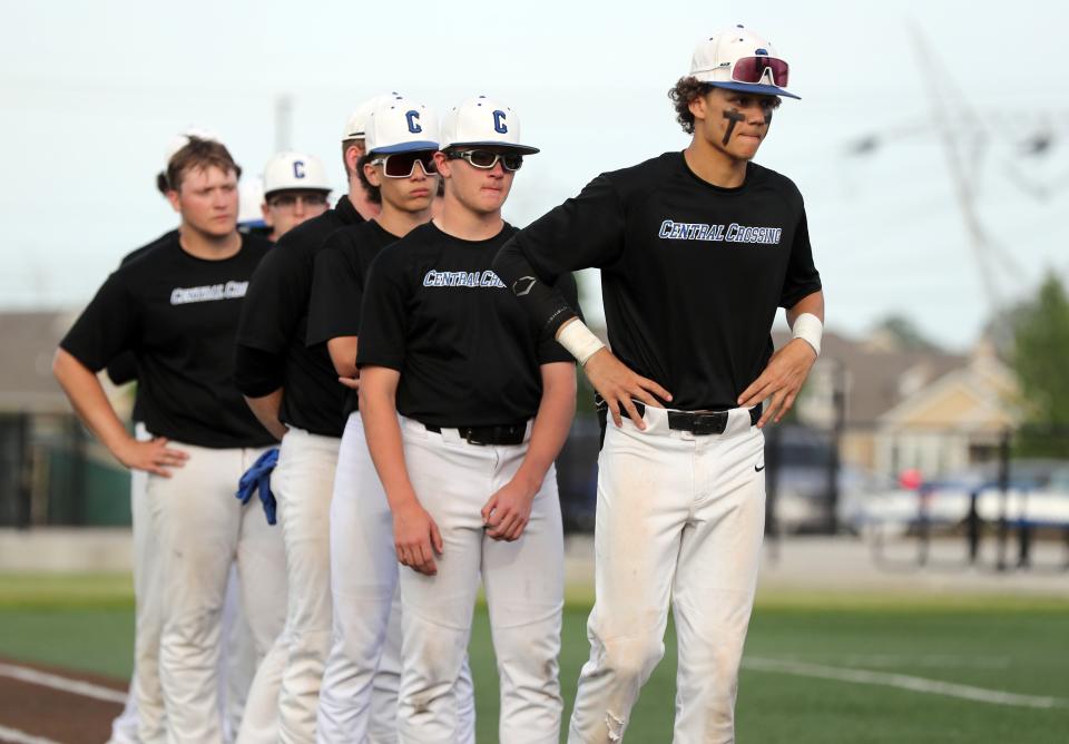 Central Crossing's Marquise Loring, front, Elisha Jackson and the rest of the Comets wait to receive their district runner-up medals after a 3-2 loss to Westerville North in a Division I district final May 25 at Olentangy Liberty.