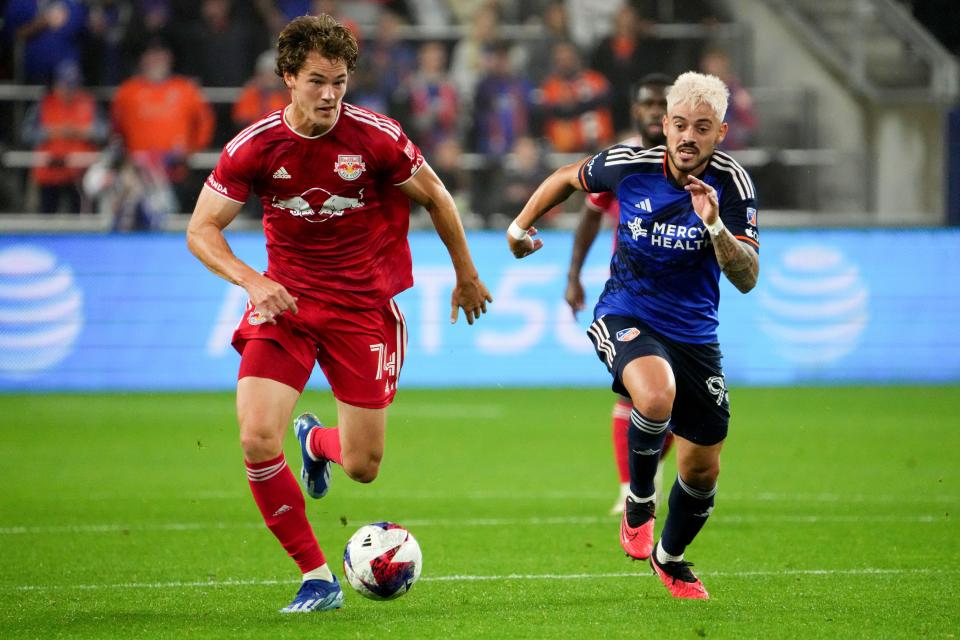 New York Red Bulls forward Tom Barlow (74) breaks forward as FC Cincinnati midfielder Júnior Moreno (93) defends in the first half of an MLS first-round playoff game, Sunday, Oct. 29, 2023, at TQL Stadium in Cincinnati.