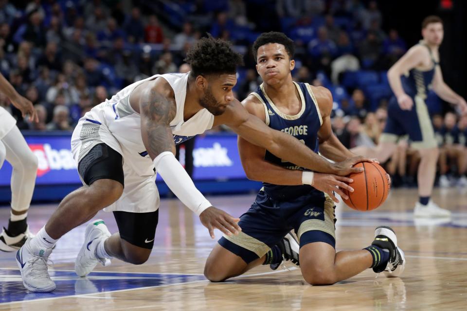 George Washington's Jameer Nelson Jr., right, and Saint Louis' Hasahn French battle vie for a loose ball during the first half of an NCAA college basketball game Wednesday, Jan. 8, 2020, in St. Louis. (AP Photo/Jeff Roberson)