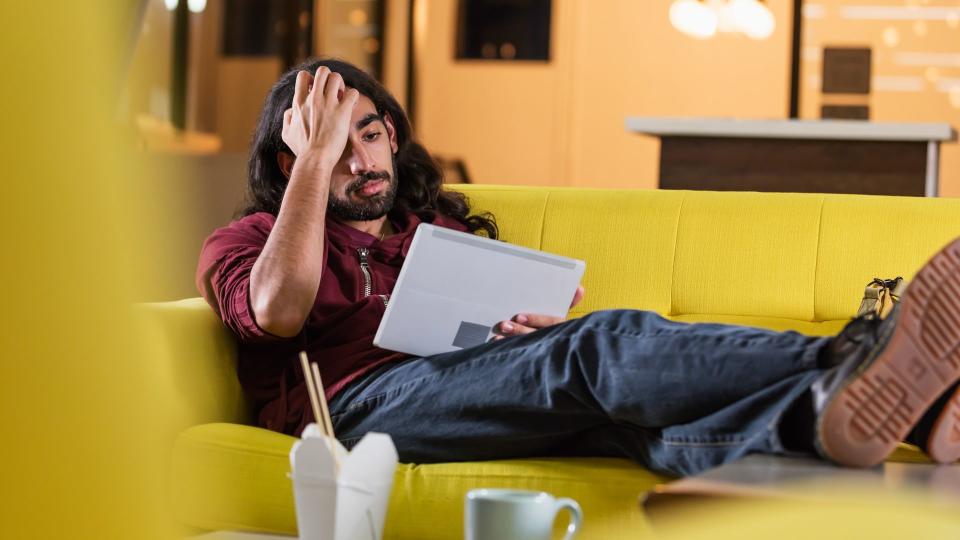 A young mixed race Indian and Caucasian man, in his 20s, with long black hair, beard and mustache.