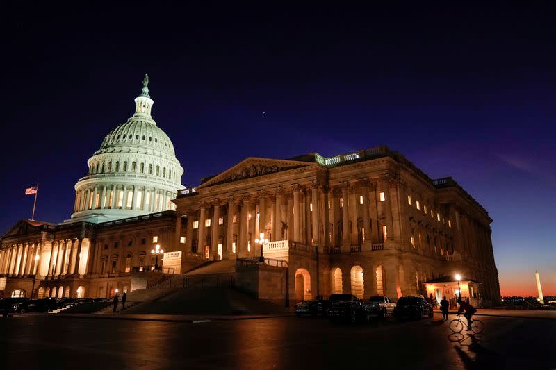 FILE PHOTO: The U.S. Capitol stands as evening falls on the first day of the Trump impeachment trial in Washington.