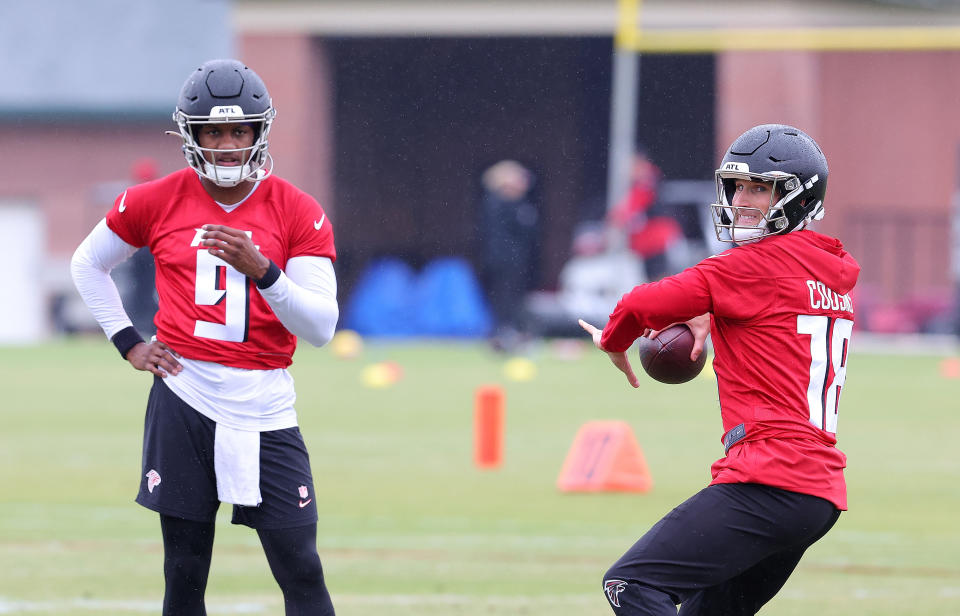 FLOWERY BRANCH, GEORGIA - MAY 14: Quarterback Kirk Cousins #18 of the Atlanta Falcons looks to pass as quarterback Michael Penix Jr. #9 looks on during OTA offseason workouts at the Atlanta Falcons training facility on May 14, 2024 in Flowery Branch, Georgia. (Photo by Kevin C. Cox/Getty Images)