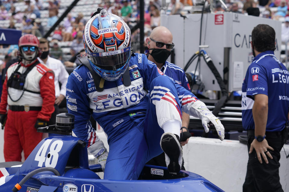 Tony Kanaan, of Brazil, climbs out of his car during qualifications for the Indianapolis 500 auto race at Indianapolis Motor Speedway, Saturday, May 22, 2021, in Indianapolis. (AP Photo/Darron Cummings)