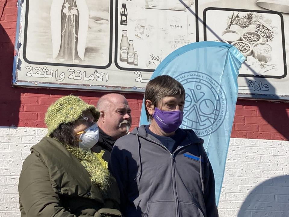 Darlett Sowers clutches the arm of her husband, Ernie Sowers, while Chuck Isbell stands behind during a memorial service for 38 pedestrians killed in Nashville in 2021. The Sowers' 36-year-old son Josh Sowers was killed crossing a street in Oct. 2020. Isbell's 13-year-old son Nate was killed by a speeding driver in Rutherford County on Halloween the same year.