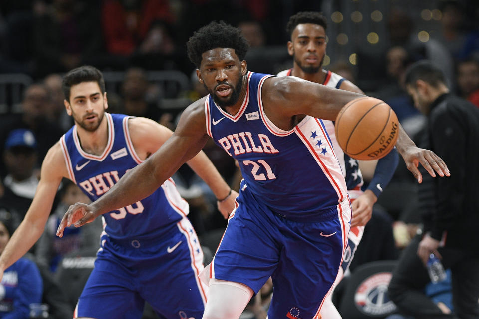 Philadelphia 76ers center Joel Embiid (21) chases the ball during the first half of the team's NBA basketball game against the Washington Wizards, Thursday, Dec. 5, 2019, in Washington. (AP Photo/Nick Wass)