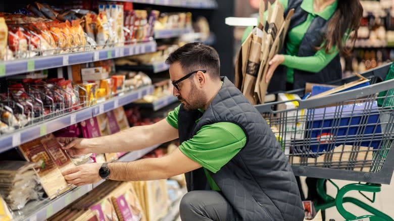 Grocery store employee stocking shelves