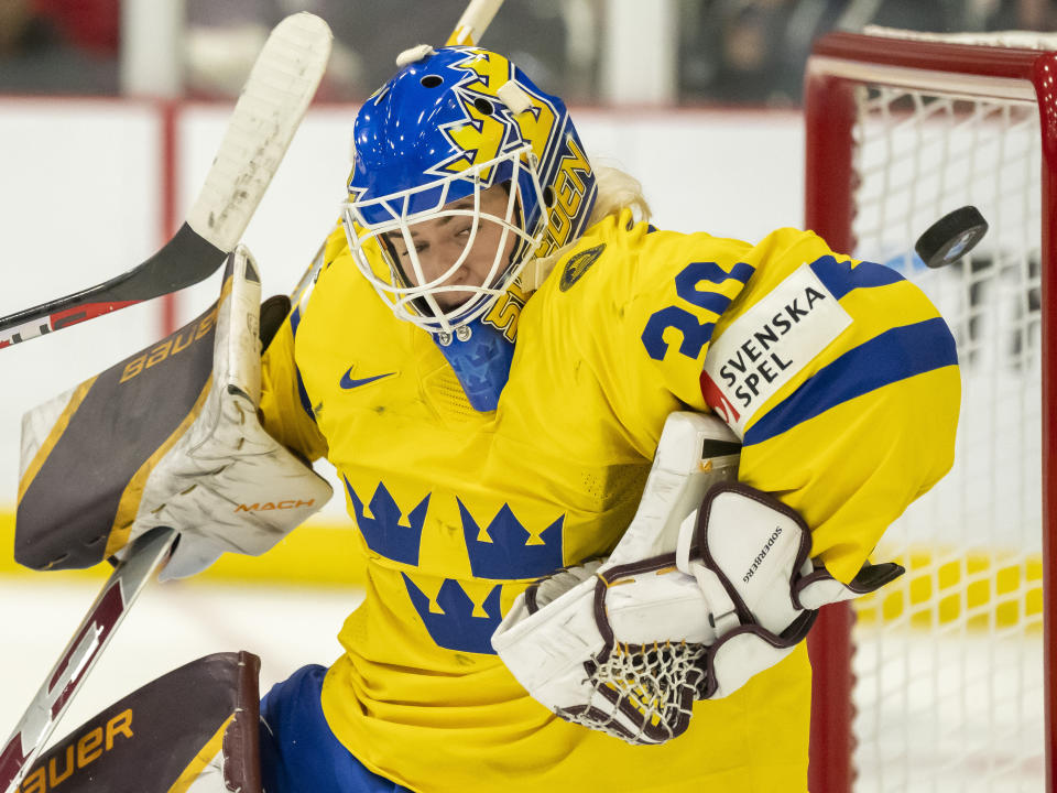 Sweden goaltender Emma Soderberg (30) makes a save against Canada during the third period of a quarterfinal match at the women's world hockey championships in Brampton, Ontario, Thursday, April 13, 2023. (Frank Gunn/The Canadian Press via AP)