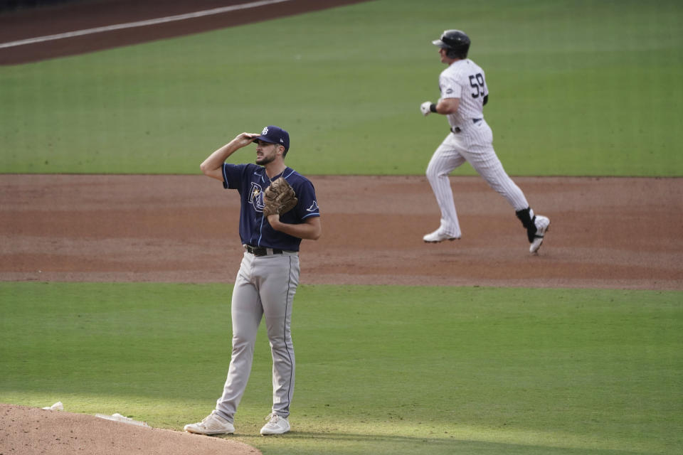 New York Yankees' Luke Voit, right, rounds the bases after hitting a solo home run off of Tampa Bay Rays starting pitcher Ryan Thompson during the second inning in Game 4 of a baseball American League Division Series Thursday, Oct. 8, 2020, in San Diego. (AP Photo/Jae C. Hong)