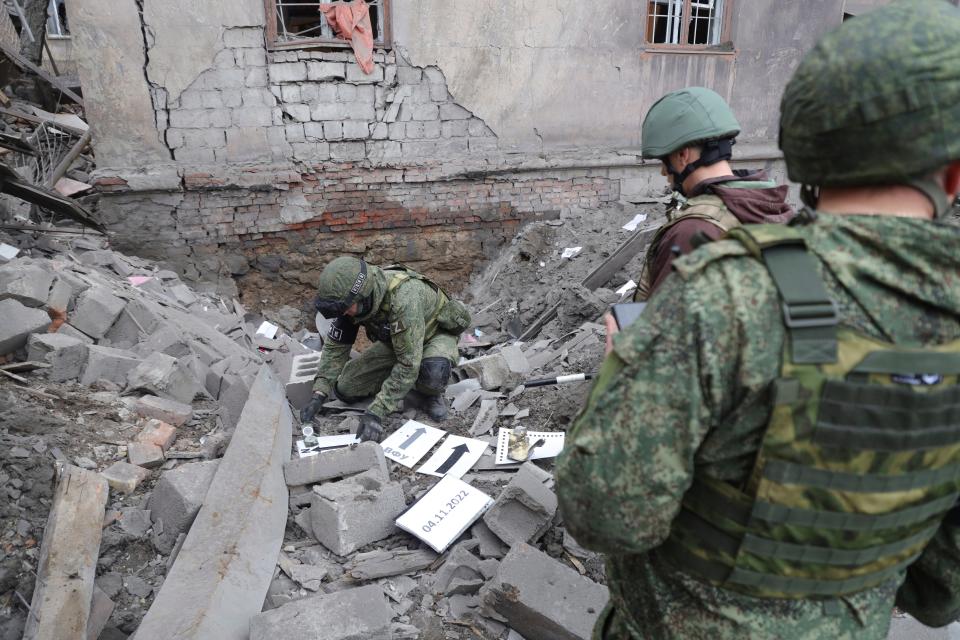 Investigators inspect a site of an apartment building after shelling by Ukrainian forces in Makiivka, Donetsk People's Republic, (AP)