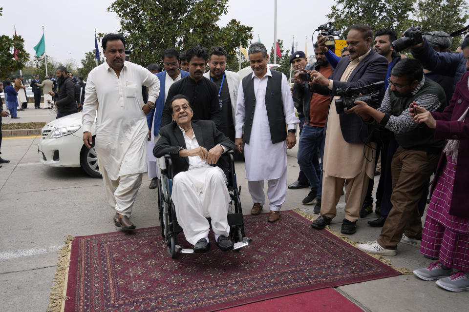 Muhammad Yousuf Talpur, foreground centre, Pakistan's newly elected lawmaker from Pakistan Peoples Party Parliamentarians arrives to attend the opening session of parliament, in Islamabad, Pakistan, Thursday, Feb. 29, 2024. Pakistan's National Assembly swore in newly elected members on Thursday in a chaotic scene, as allies of jailed former Premier Khan protested what they claim was a rigged election. (AP Photo/Anjum Naveed)