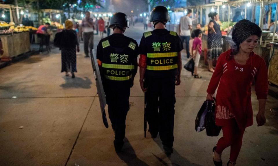 Police in Kashgar, in China’s Xinjiang Uighur autonomous region, patrol a night food market