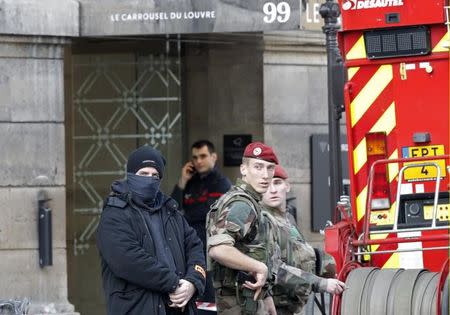 French police, soldiers and firefighters are seen in front of the street entrance of the Carrousel du Louvre in Paris, France, February 3, 2017 after a French soldier shot and wounded a man armed with a machete and carrying two bags on his back as he tried to enter the Paris Louvre museum. REUTERS/Christian Hartmann