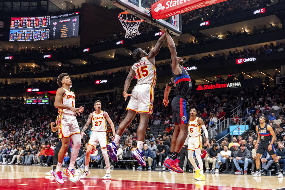 Atlanta Hawks center Clint Capela (15) blocks a shot by Detroit Pistons center Jalen Duren (0) during the first half of an NBA basketball game, Wednesday, April 3, 2024, in Atlanta. (AP Photo/Jason Allen)