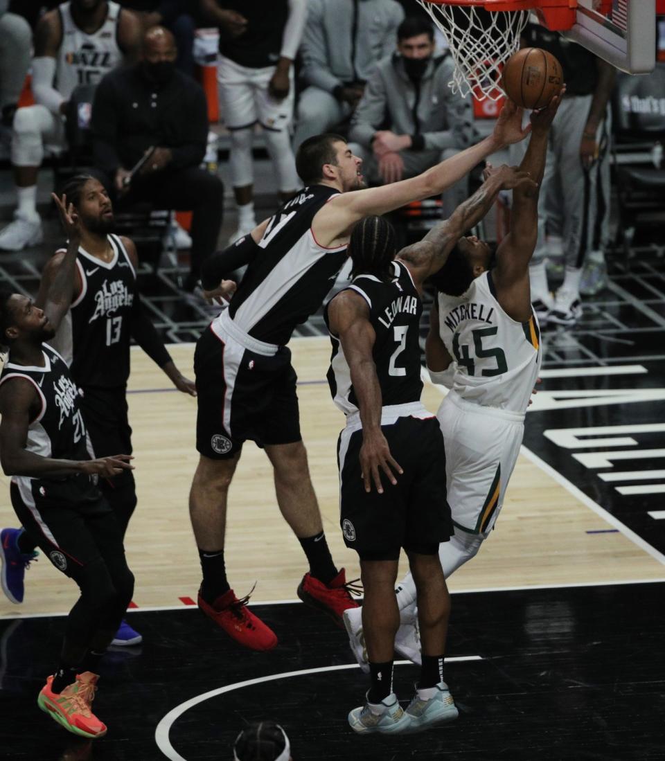 Clippers center Ivica Zubac blocks a shot by Jazz guard Donovan Mitchell.