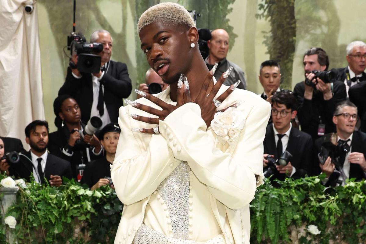 Lil Nas X rocks a glittery suit, blonde hair and extra-long acrylic nails for the 2024 Met Gala