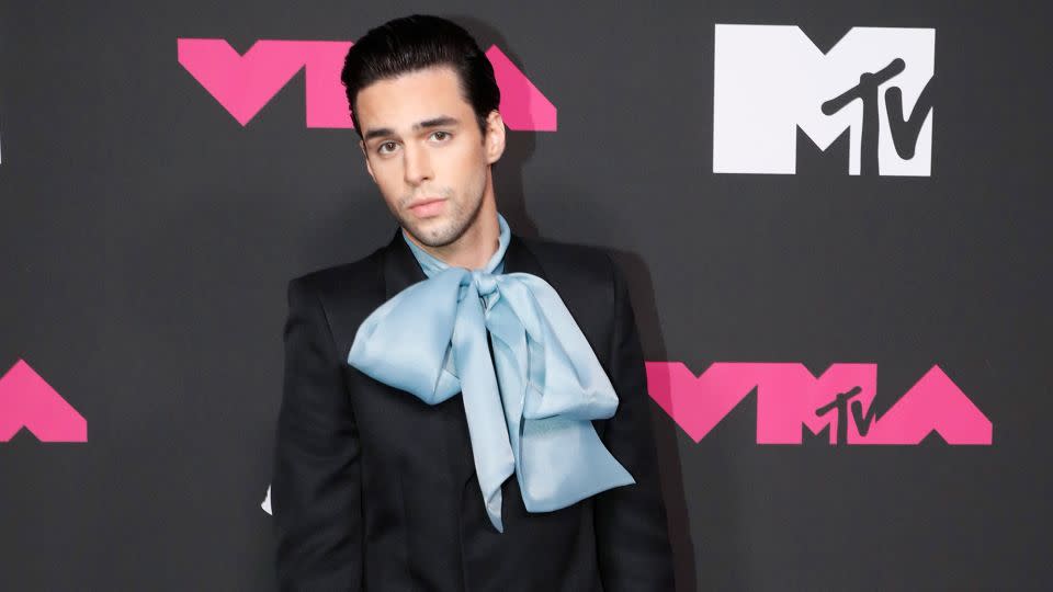 Up-and-coming singer-songwriter Stephen Sanchez was all wrapped up in a black suit with an oversized baby-blue bow, a black Gucci bamboo handle Diana tote bag and black leather boots.  - Johnny Nunez/Getty Images