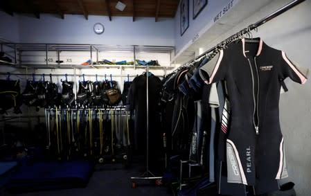 Diving costumes and equipment room is seen at Pearl Divers, a diving school at Unawatuna beach in Galle