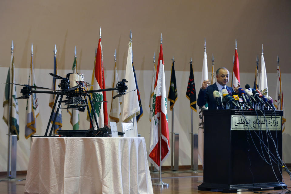 Lebanese Defense Minister Elias Bou Saab speaks next to part of an Israeli drone that crashed in southern Beirut last month during a press conference to announce the results of an investigation into the incident, at the Lebanese Defense Ministry, in Yarzeh near Beirut, Lebanon, Thursday, Sept. 19, 2019. The investigation has concluded that two Israeli drones that crashed in the Lebanese capital last month were on an attack mission, one of them armed with 4.5 kilograms of explosives. (AP Photo/Bilal Hussein)