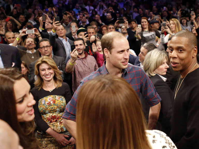 Britain's Prince William, second from right, talks with rapper and entrepreneur Jay-Z , far right, as Kate, left, the Duchess of Cambridge, chats with Jay Z's wife, entertainer Beyonce, foreground center, during an NBA basketball game between the Cleveland Cavaliers and the Brooklyn Nets at the Barclays Center in New York, Monday, Dec. 8, 2014. (AP Photo/Kathy Willens)