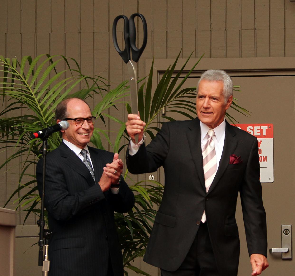 Harry Friedman, executive producer of Sony Pictures Television (l.) and host Alex Trebek pose during ribbon cutting at Sony Pictures for the 28th season premiere of "Jeopardy!" on Sept. 20, 2011 in Culver City, Calif.