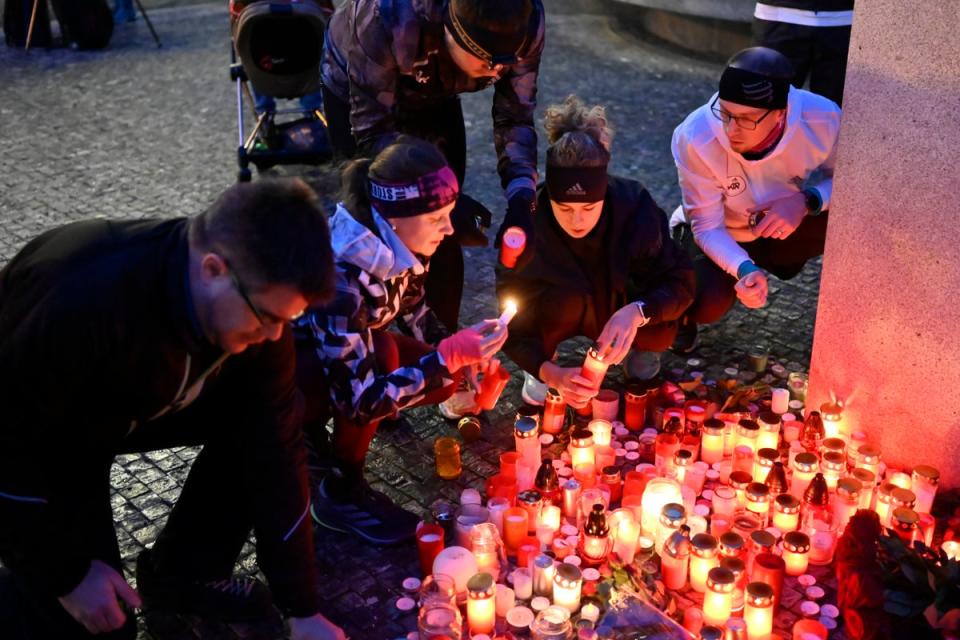 Mourners laying candles outside Charles University (Copyright 2023 The Associated Press. All rights reserved)