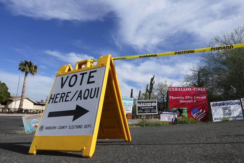 FILE - A voting sign points voters in the right direction to drop off ballots in Phoenix, Monday, Nov. 7, 2022. On Friday, Nov. 18, The Associated Press reported on stories circulating online incorrectly claiming the fact that incumbent Republican state treasurer Kimberly Yee got tens of thousands more votes than GOP gubernatorial candidate Kari Lake shows the Arizona election was rigged. (AP Photo/Ross D. Franklin, File)