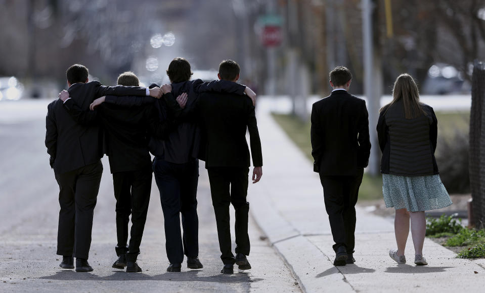 A group of young people walk away following graveside services of the Haight and Earl families in La Verkin, Utah, on Friday, Jan. 13, 2023, in La Verkin, Utah. Tausha Haight, her mother, Gail Earl, and her five children were shot and killed by her husband Jan. 4. (Scott G Winterton/The Deseret News via AP)