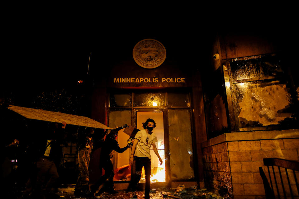 Protesters set fire to the entrance of the 3rd precinct on May 28. | Carlos Barria—Reuters