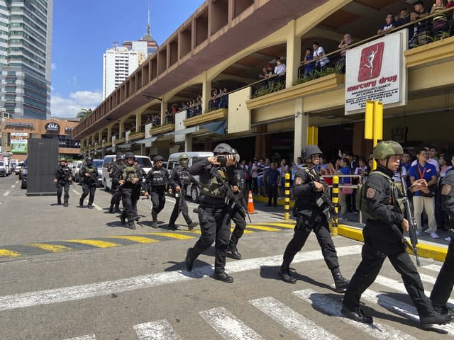 A group of armed police arrive at the Greenhills Shopping Centre in Manila 