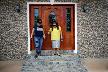 Sisters Emily and Isilda Hernandez leave Emily's house in Intipuca, El Salvador, August 14, 2018. REUTERS/Jose Cabezas