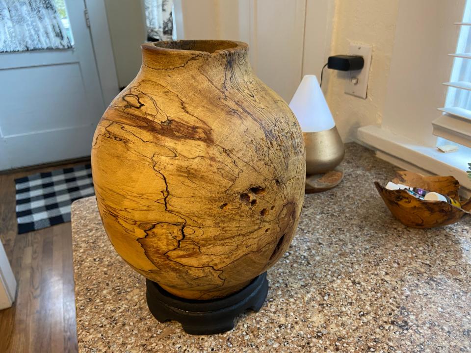 Stephen Holmes' sycamore tree trunk sculpted into a vase with black lines of spalting, the beginning of the tree's decay.