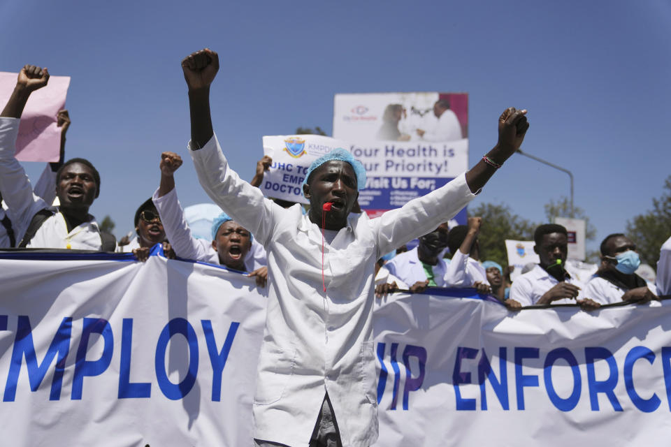 Doctors and other medical staff take part in a protest, in downtown Nairobi, Kenya, Friday, March 22, 2024. Hundreds of Kenyan doctors have protested in the streets demanding better pay and working conditions in an ongoing nationwide strike that has entered its second week. The doctors carried placards and chanted against the Kenyan government on Friday, saying it had failed to implement a raft of promises, including a collective bargaining agreement signed in 2017 after a 100-day strike during which people died from lack of care. (AP Photo/Brian Inganga)
