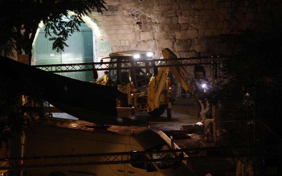 Israeli security forces take down security barriers at the Lions' Gate, a main entrance to the Al-Aqsa mosque compound in Jerusalem's Old City, on July 24, 2017 - Credit: AFP