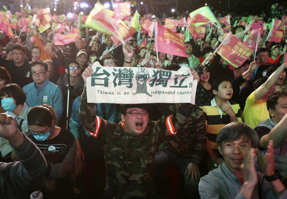 Supporters of Taiwan's presidential election candidate, Taiwan president Tsai Ing-wen cheer for her victory as they gather to watch early election returns in Taipei, Taiwan, Saturday, Jan. 11, 2020. The banner, center, reads "Taiwan Is An Independent Country". (AP Photo/Chiang Ying-ying)