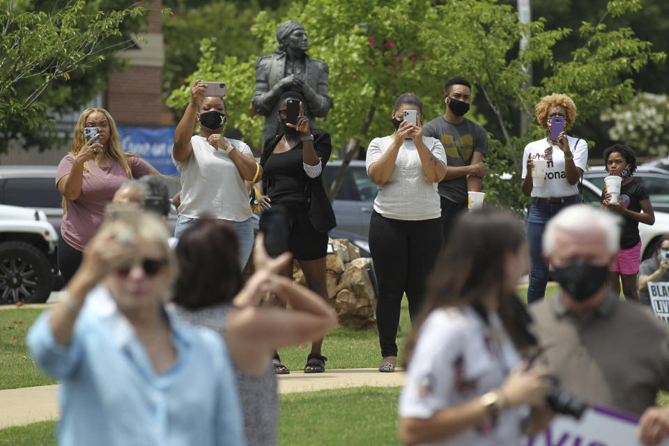 Spectators gather at Fairpark in Tupelo Mississippi Monday, June 29, 2020, to watch the State Flag of Mississippi come down from City Hall. Mississippi is retiring the last state flag in the U.S. that includes the Confederate battle emblem. (Thomas Wells/Northeast Mississippi Daily Journal, Via AP)