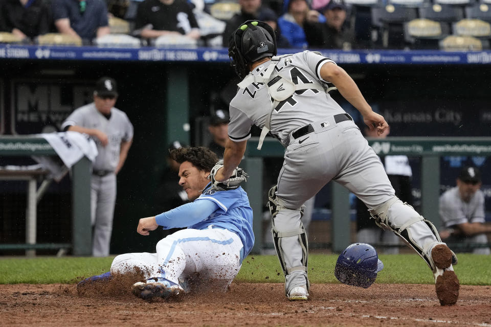 Kansas City Royals' Nick Pratto beats the tag by Chicago White Sox catcher Seby Zavala to score on a two-run double hit by Maikel Garcia during the fourth inning of a baseball game Thursday, May 11, 2023, in Kansas City, Mo. (AP Photo/Charlie Riedel)