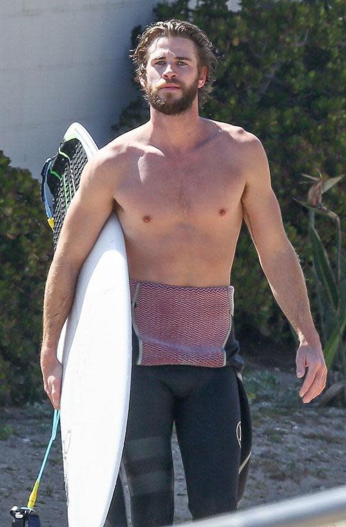 Liam Hemsworth bares all before a day in the surf