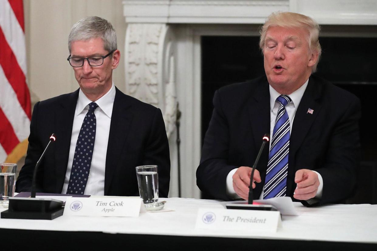 Apple CEO Tim Cook listens to US President Donald Trump deliver opening remarks during a meeting of the American Technology Council: Getty Images