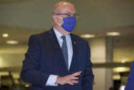 France's Ambassador to Australia Jean-Pierre Thebault gestures as he arrives at Sydney Airport, Saturday, Sept. 18, 2021. Thebault has described as a "huge mistake" Australia's surprise cancellation of a major submarine contract in favor of a U.S. deal, in an unprecedented show of anger among the allies. (AP Photo/David Gray)