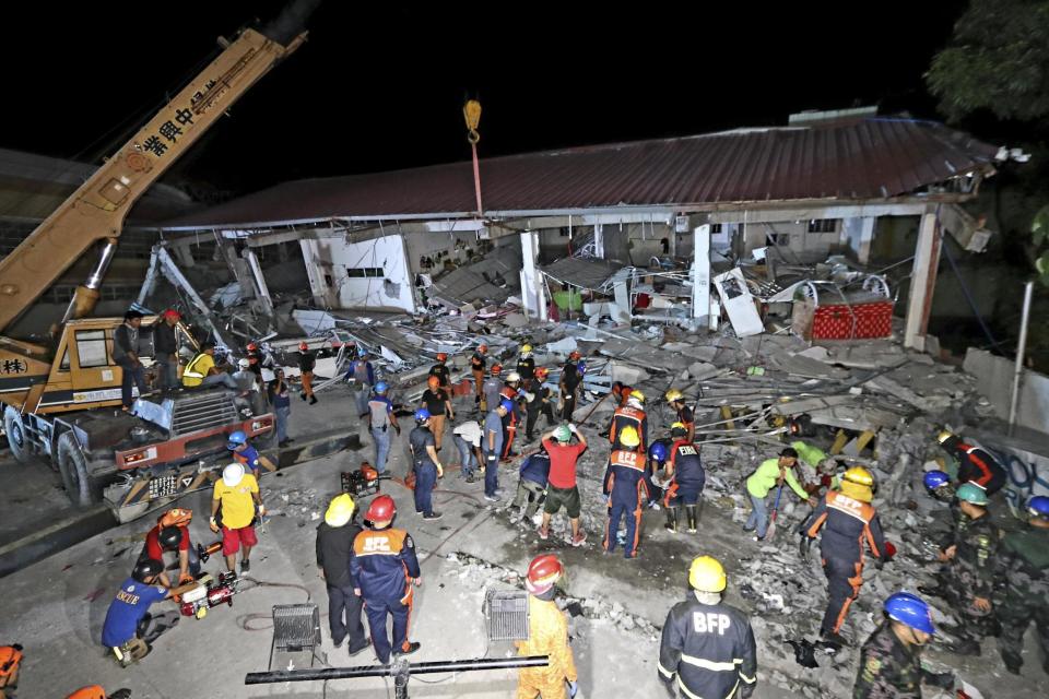 Emergency responders at the site of a damaged building (EPA)