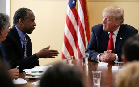 Republican U.S. presidential nominee Donald Trump listens to former presidential candidate Dr. Ben Carson during a meeting with local small business leaders before a campaign rally in West Palm Beach, Florida, U.S., October 13, 2016. REUTERS/Mike Segar/File Photo