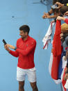 Serbia's Novak Djokovic poses for selfie after defeating France's Quentin Halys during their Round of 16 match at the Adelaide International Tennis tournament in Adelaide, Australia, Thursday, Jan. 5, 2023. (AP Photo/Kelly Barnes)