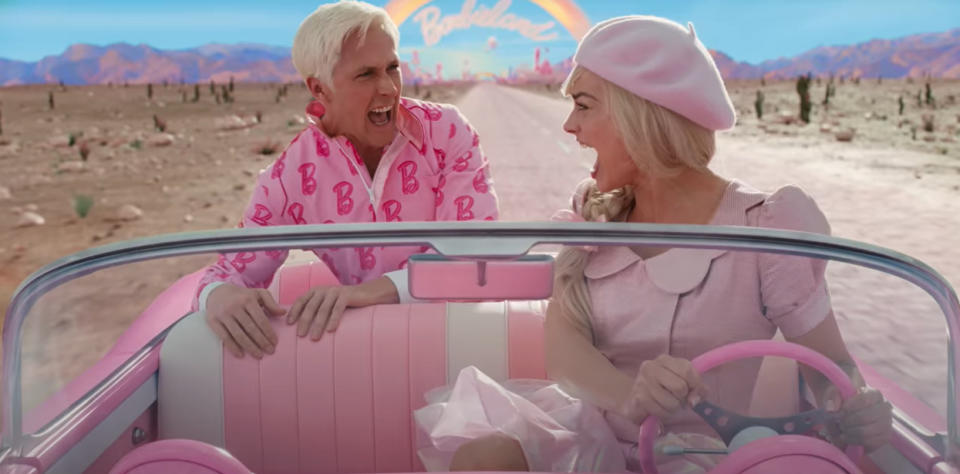 Ryan Gosling and Margot Robbie in the Barbie movie, screaming and driving a convertible on a desert road.