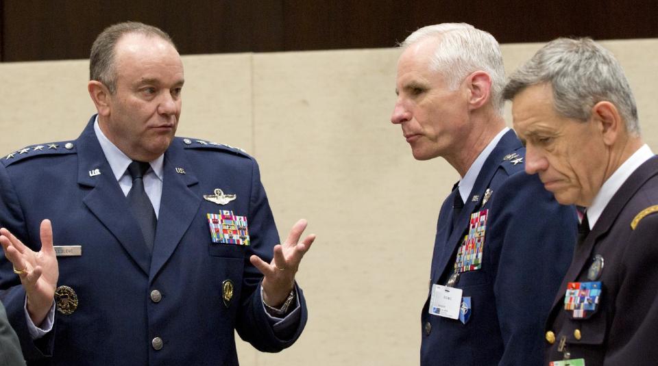 U.S. Air Force Gen. Philip Breedlove, left, the Supreme Allied Commander in Europe, speaks to colleagues during a meeting of the North Atlantic Council with Non-NATO ISAF Contributing Nations at NATO headquarters in Brussels on Wednesday, April 2, 2014. (AP Photo/Virginia Mayo)