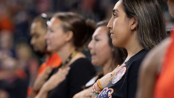 PHOTO: Uvalde resident Faith Mata takes a moment of silence for the Uvalde children that were killed in the mass shooting before the Astros versus Athletics game in Houston, Aug. 14, 2022. (Thomas Shea/USA Today Sports via Reuters)