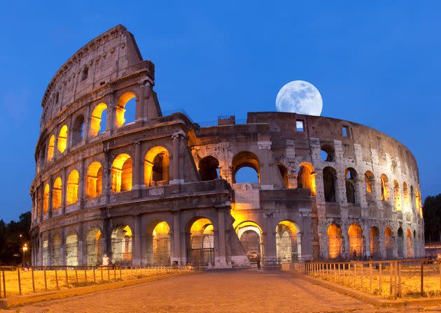 A photo of the Colosseum in Rome at moonrise in May.